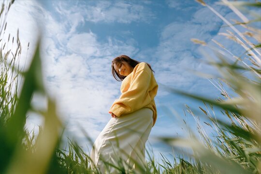 Low angle view of a woman in a sunny field