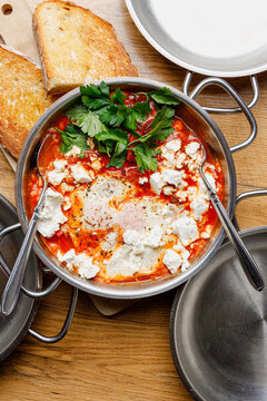 Shakshuka with cheese in a skillet (close-up, isolated image)