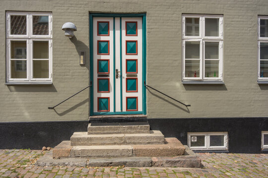 Traditional scandinavian building facade with colorful decorated wooden double door