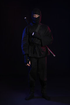 Male ninja on black background
