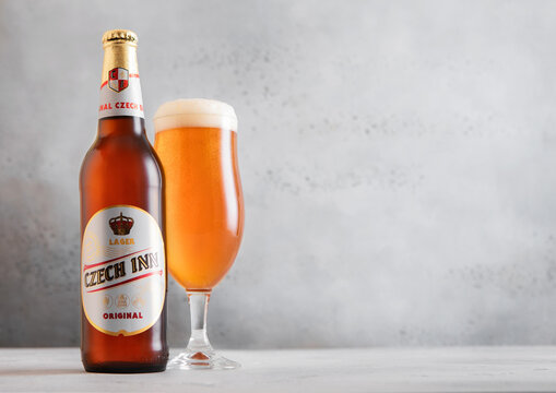 LONDON,UK - MARCH 26, 2026: Bottle and glass of Czech Inn lager beer on light table background.