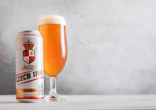 LONDON,UK - MARCH 26, 2026: Czech Inn lager beer in aluminium can and glass on light table background.