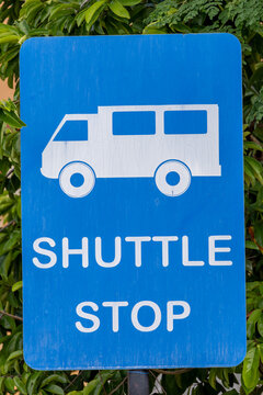 Blue Shuttle Stop Sign with White Minibus Icon