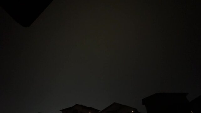 Video of Lightning Above Residential Houses at Night Capturing a Powerful Thunderstorm Over a Quiet Neighbourhood
