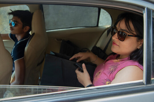 Son driving his mother in the  car 