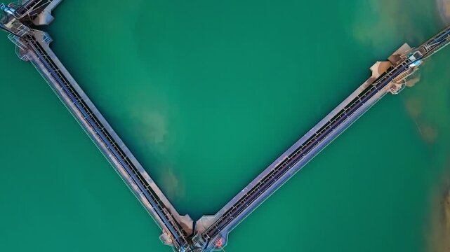 Gravel pit extraction facility on mineral-rich turquoise lake