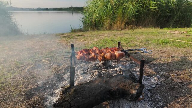 Meat grilling on hot coals outdoors