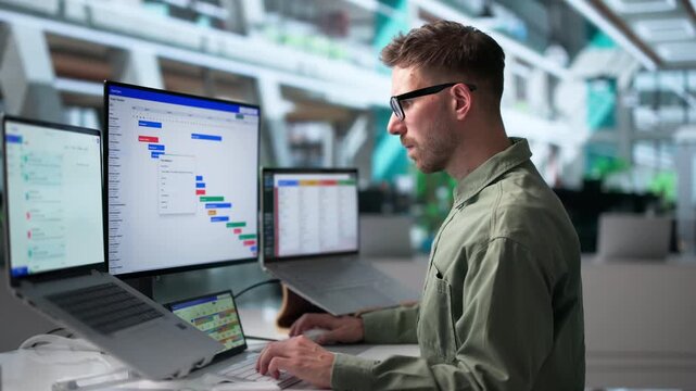Agile Project Manager Reviews Task Schedule Using Laptop
