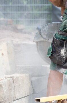 Masonry saw / brick saw in use at construction site to build a stone wall