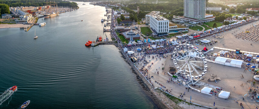 Aerial view of Travem&uuml;nder Woche festival with a ferris wheel on the beach and the Trave river in Travem&uuml;nde, Germany.