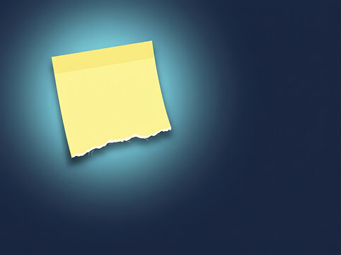Yellow sticky note with torn edge on dark blue background