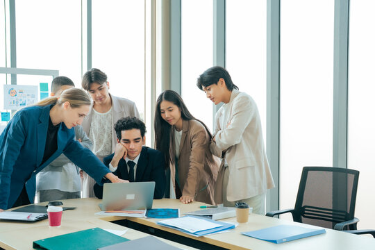 Business colleagues reviewing project information together. Team collaboration, business planning, leadership workplace communication improve productivity and decision making.