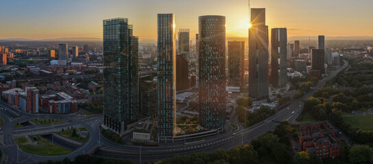 Fototapeta premium Golden Sun Flare Behind Deansgate Square Skyscrapers in Manchester at Dawn