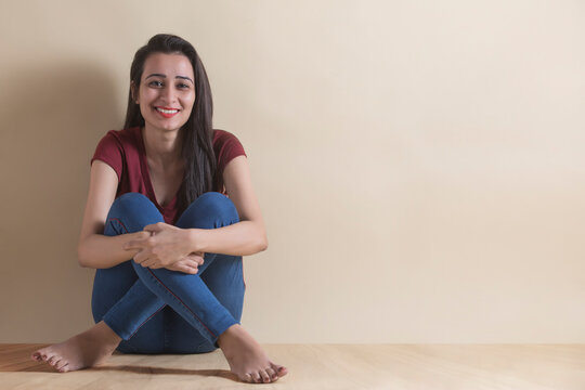 Happy young girl sitting in joy