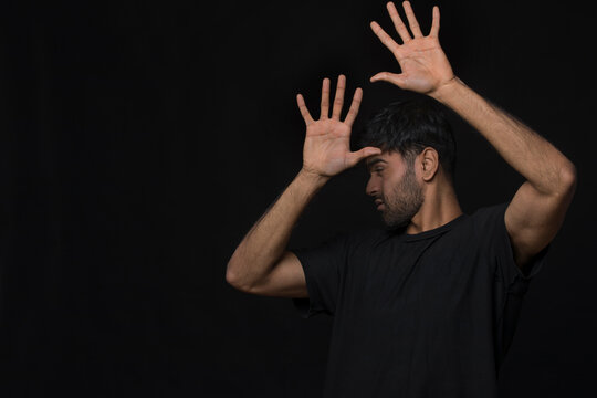 man with seasonal disorder blocking light with hands