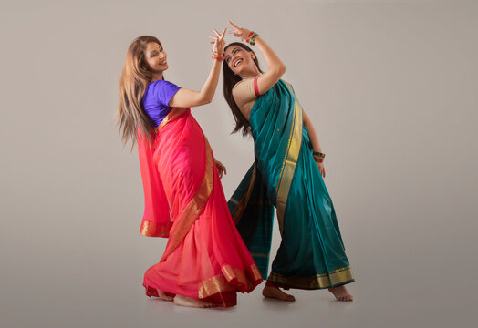 young women dancing in saree