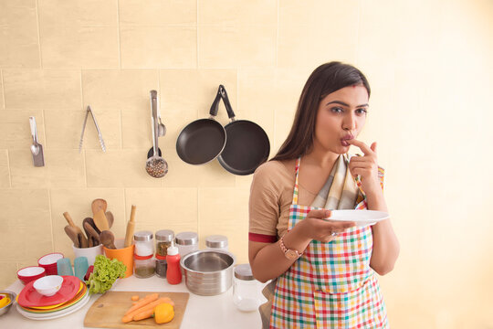 woman in saree standing in the kitchen