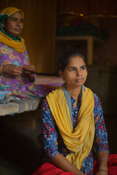 mother braiding her daughter's hair 