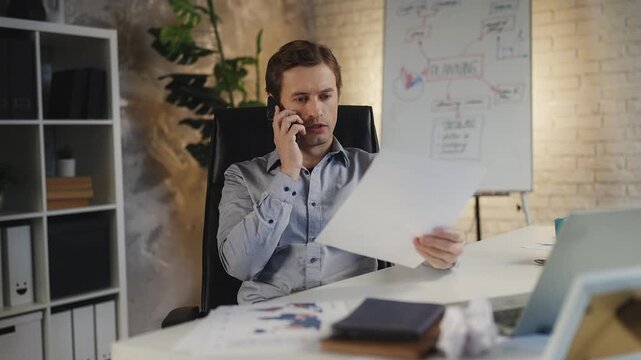 Irritated businessman scolding employee for mistakes on phone, stressful job