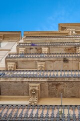 Wrought Iron Balconies and Stone Details of Traditional Building, Barcelona, Low Angle View of Classical Residential Facade © ikuday