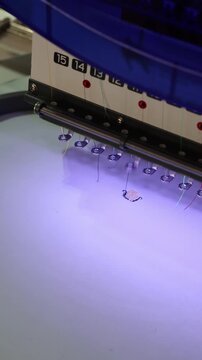 Industrial embroidery machine stitching logo on fabric