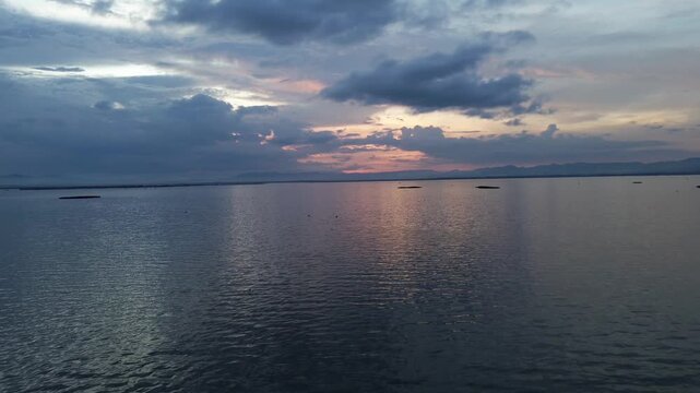 Aerial View of Dramatic Sunset Over Calm Lake Water