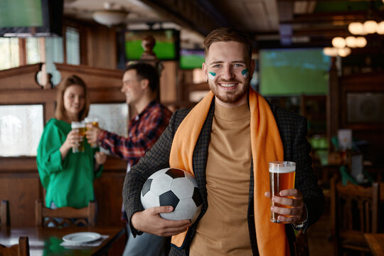 Friends exchanging smiles and clinking glasses during match