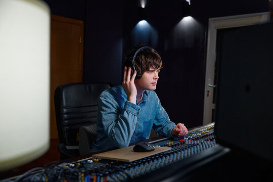 Fine-tuning audio with precision. Adjusting mix levels with attentive focus
