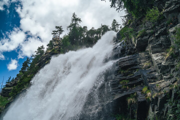Powerful Alpine Waterfall Cascading Over Rocky Cliff in Austria © Török Balázs
