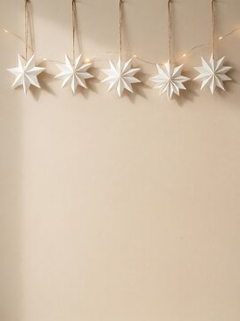 Scandinavian Minimal Christmas Background with Handmade Paper Stars, Pine Branches and Copy Space