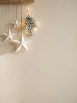 Scandinavian Minimal Christmas Background with Handmade Paper Stars, Pine Branches and Copy Space