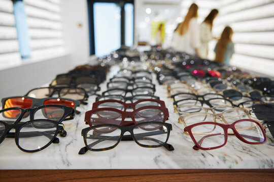 Display of glasses and sunglasses, optical store featuring organized selection of glasses