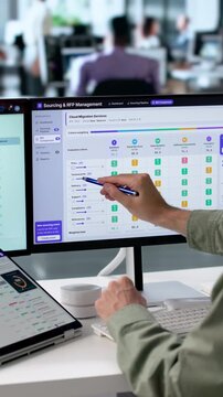 Procurement Manager Reviews Vendor Proposals Using Digital Dashboard