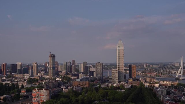 Panoramica skyline view of Rotterdam cityscape featuring the tall Zalmhaven tower and Erasmus Bridge, observed from the Euromast observation tower in the Netherlands.