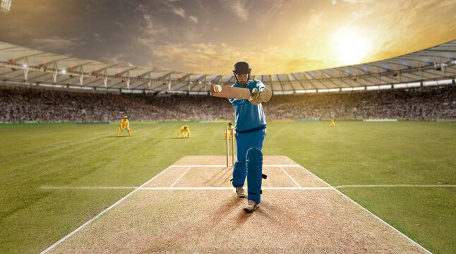 Young sportsman strikes the ball while batting in the cricket field