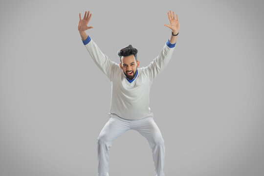 Bowler Appealing to the umpire on a grey background