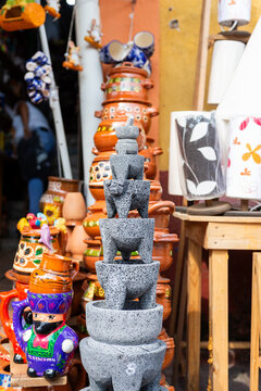 Traditional Mexican Molcajete Set Displayed at Artisan Market with Handmade Pottery