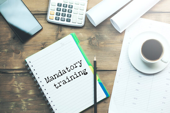 Mandatory training text on torn white paper