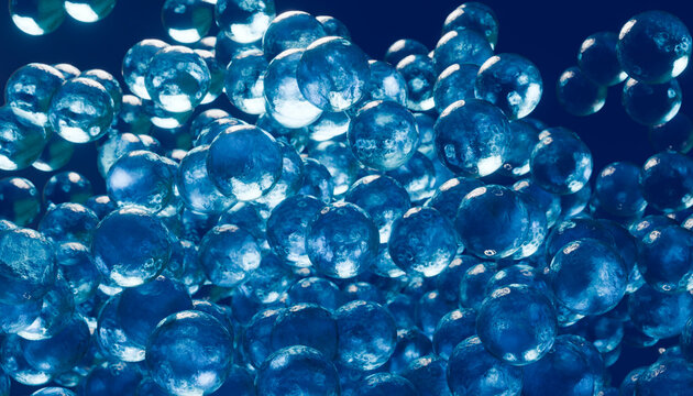 Macro close-up of floating blue translucent gel spheres