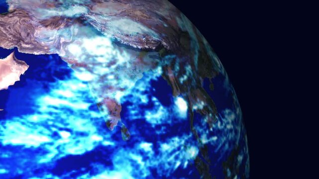 View of Earth from space showing Asia and the Indian Ocean with bright cloud cover, deep blue water, and dark background, ideal for climate, weather, and global themes.