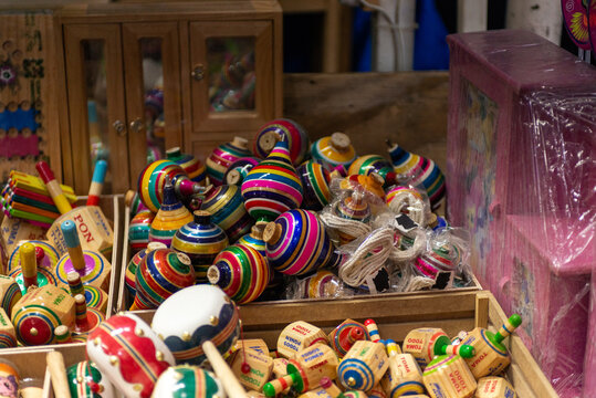 Colorful Traditional Mexican Wooden Spinning Tops Displayed at Artisan Market Stall