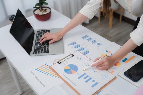 Business financing accounting banking concept. Business woman hand doing finances and calculate on desk about cost at home office. Woman working on desk with using calculator, finance accounting.	