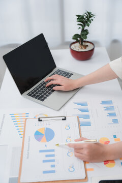 Business financing accounting banking concept. Business woman hand doing finances and calculate on desk about cost at home office. Woman working on desk with using calculator, finance accounting.	