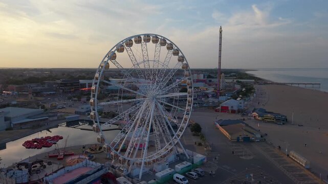 Coastal sunset seaside holiday resort of Skegness on the east coast of Lincolnshire UK, English vacation and sweeping vista views. Evening nightlife with Big Wheel rides and amusements. Pier and town