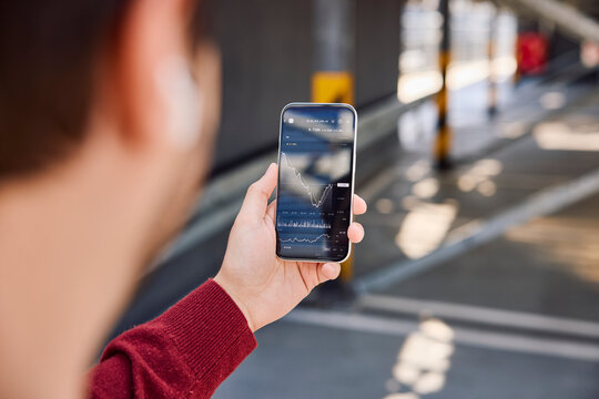 Checking stock market trading app on smartphone