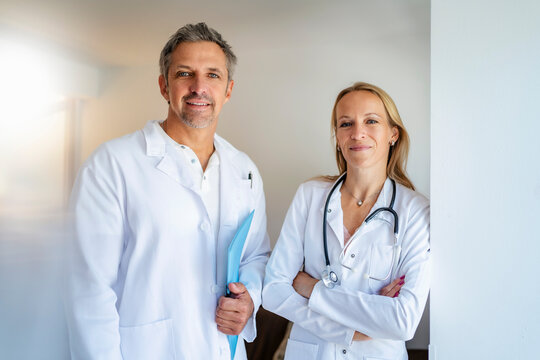 Portrait of confident male and female doctor