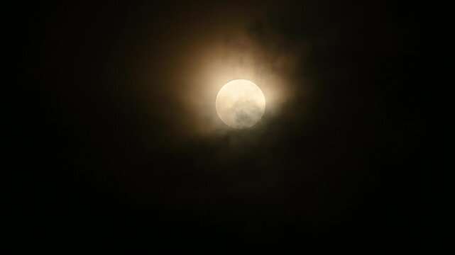 The July Full Moon is known as the ''Buck Moon'' in Native American tradition, coinciding with Guru Purnima. See black storm clouds, tree branches, electric wire, and construction, lunar corona