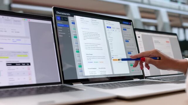 Businesswoman Reviews Document Management Software On Laptop