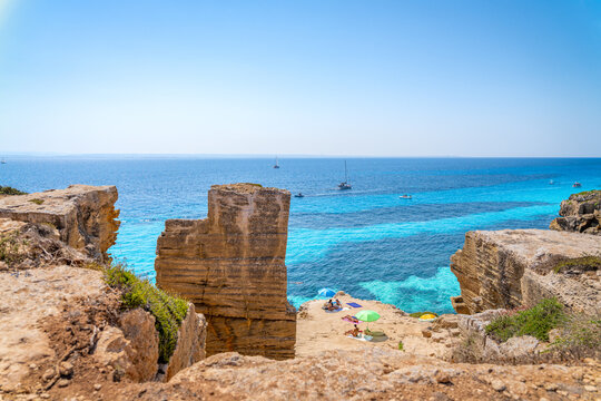 Vacationers swimming and snorkeling in the beautiful turquoise waters of Favignana beach in Sicily