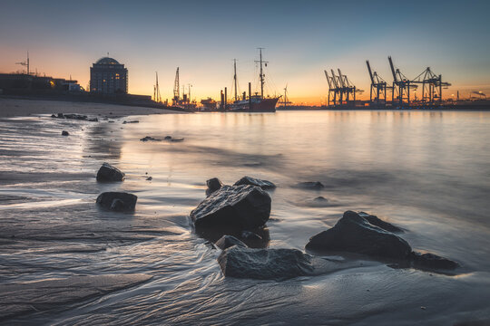 View of harbor against sky during sunset at Hamburg, Germany